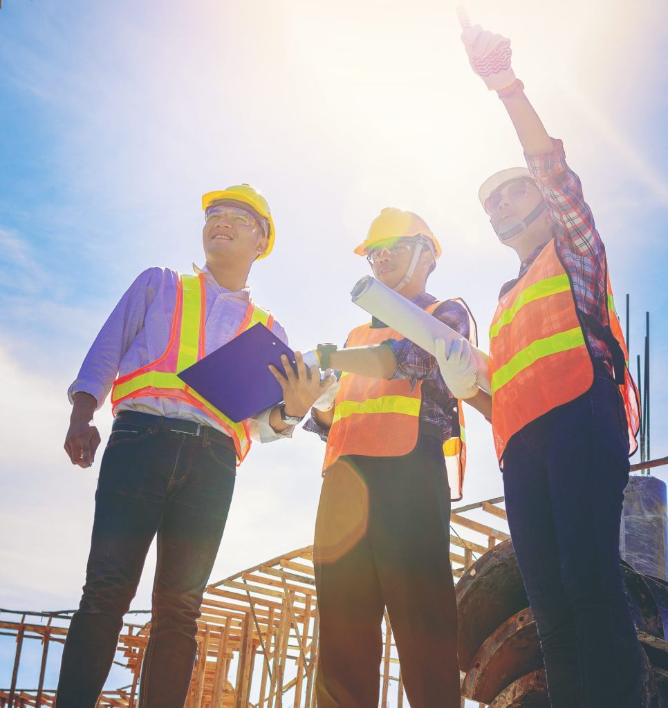 Structural Engineer And Architect And Foreman Worker With Blueprints Discuss, Plan Working For The Outdoors Building Construction Site. Construction Collaboration Concept