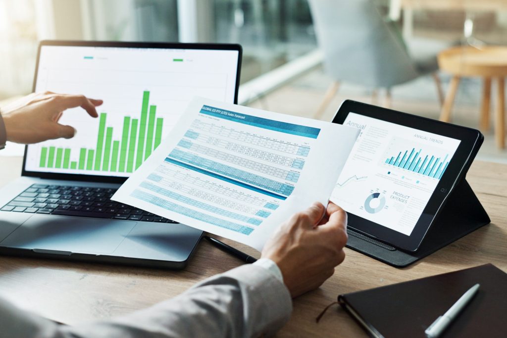 Hands, Laptop And Chart With Paper For Business Man, Analysis Or Check Progress Of Economy, Investment Or Profit. Financial Agent, Pc And Reading Graph For Data Document, Growth Or Numbers For Future