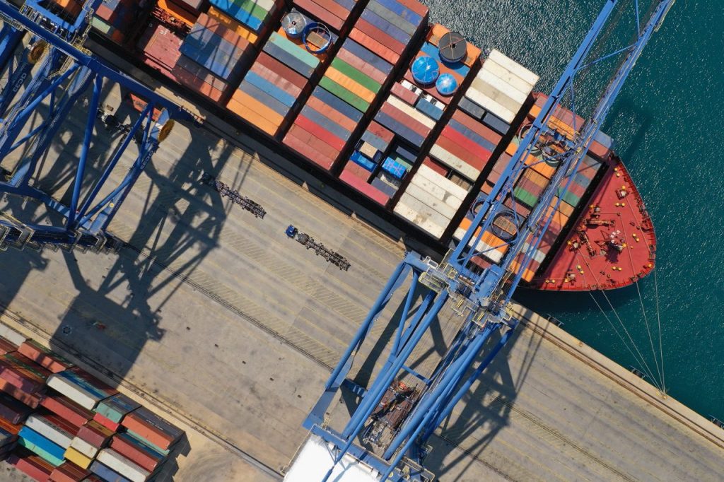 Aerial Top Down Ultra Wide Photo With Copy Space Of Industrial Cargo Container Ship Loading In Logistics Terminal Port