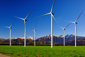 Wind Turbine Farm with Mountain backdrop In New Zealand
